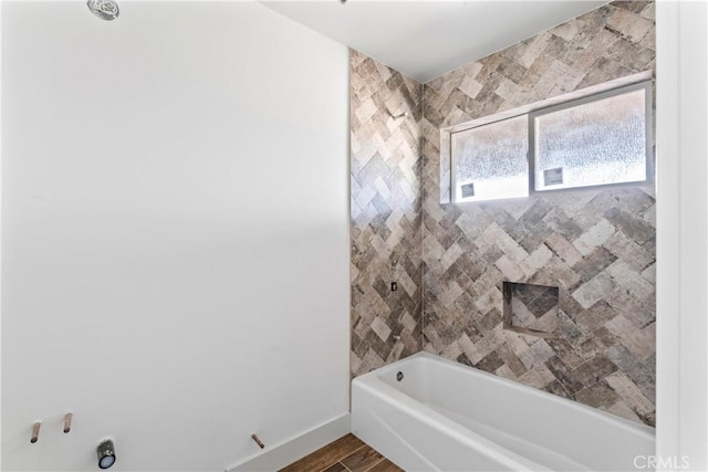 full bath featuring shower / bath combination, baseboards, and wood finished floors