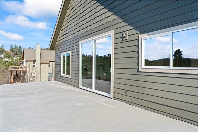view of side of home with a patio