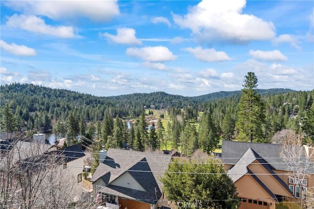 birds eye view of property with a wooded view