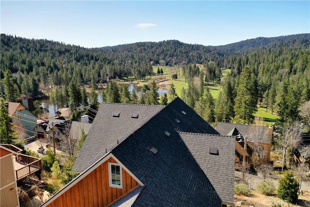 birds eye view of property featuring a view of trees
