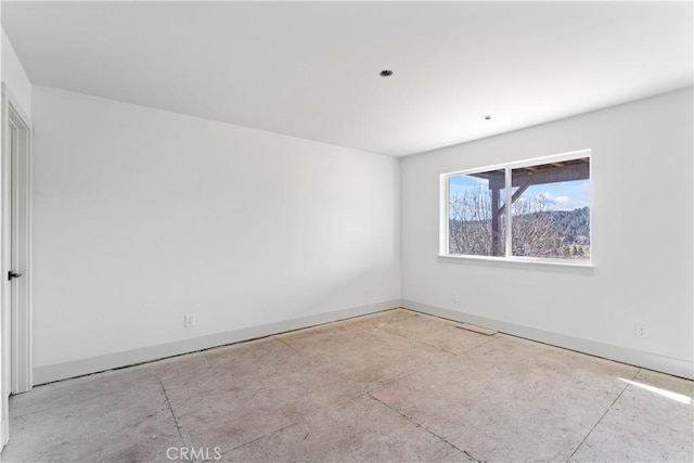 unfurnished room featuring baseboards
