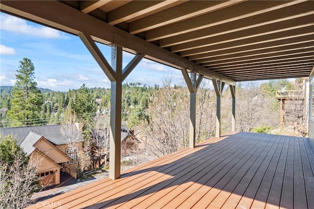 wooden terrace with a wooded view
