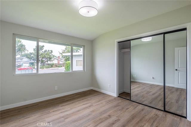 9128 Gerald Ave, Northridge, CA 91343 - unfurnished bedroom with wood finished floors, a closet, and baseboards
