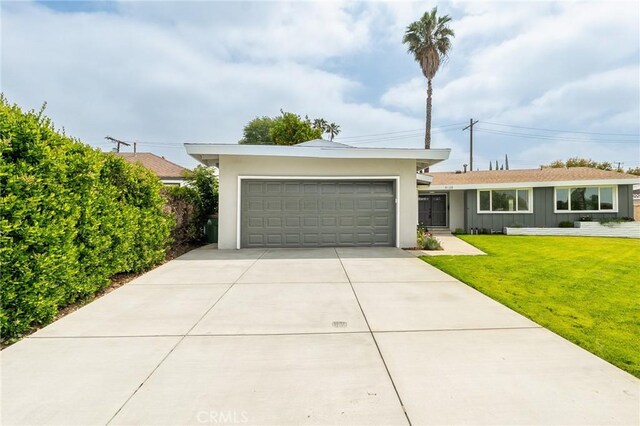 9128 Gerald Ave, Northridge, CA 91343 - ranch-style house featuring a front yard, a garage, board and batten siding, concrete driveway, and stucco siding