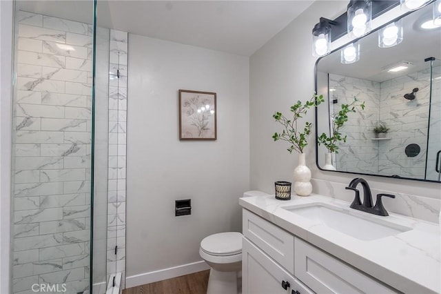 9128 Gerald Ave, Northridge, CA 91343 - bathroom featuring a stall shower, wood finished floors, toilet, vanity, and baseboards