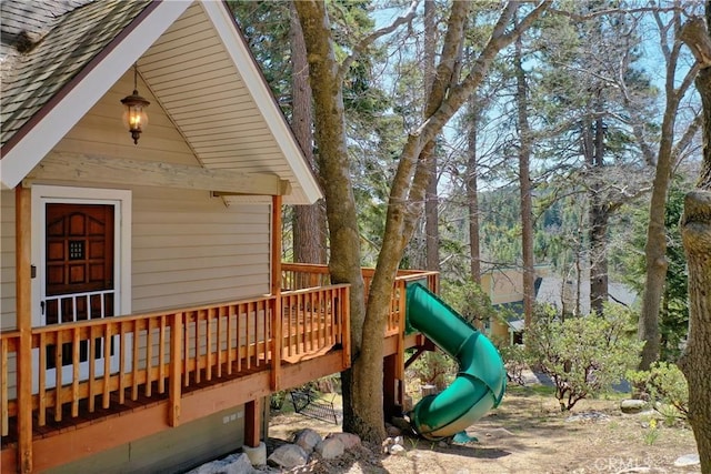 26375 Augusta Dr, Lake Arrowhead, CA 92352 - wooden deck featuring an attached garage and a playground