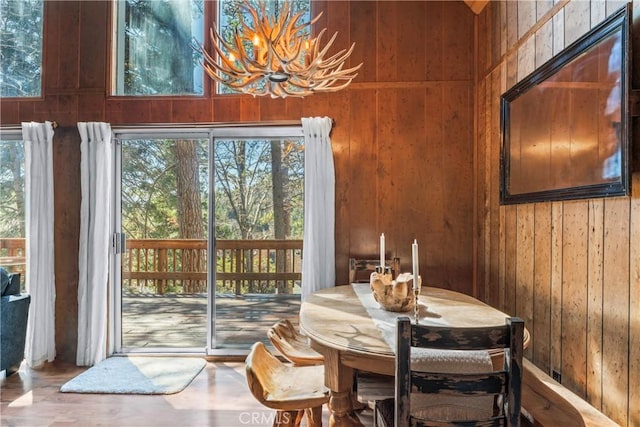 26375 Augusta Dr, Lake Arrowhead, CA 92352 - dining area with a chandelier, wood walls, and plenty of natural light