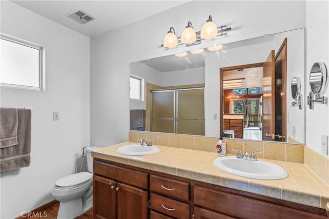 26375 Augusta Dr, Lake Arrowhead, CA 92352 - bathroom featuring a shower stall, double vanity, visible vents, and a sink