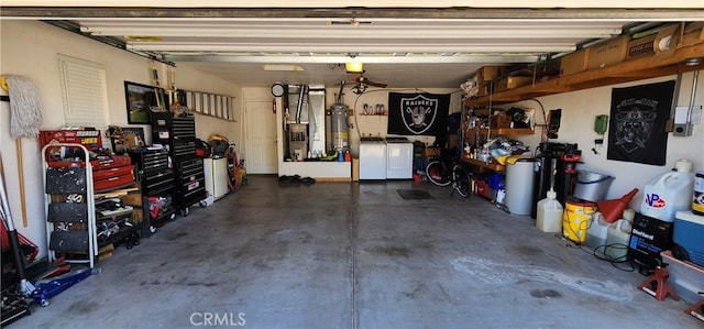 garage with secured water heater, heating unit, and separate washer and dryer