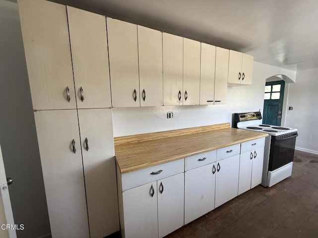 kitchen with arched walkways, dark wood finished floors, range with electric cooktop, and light countertops