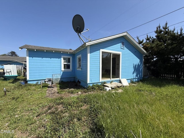 rear view of house with a yard