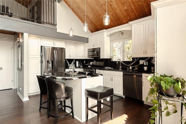 27482 Matterhorn Dr, Lake Arrowhead, CA 92352 - kitchen featuring appliances with stainless steel finishes, dark countertops, tasteful backsplash, wooden ceiling, and white cabinetry