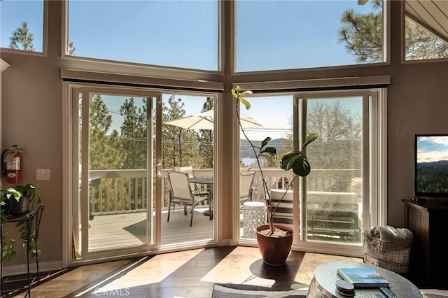 27482 Matterhorn Dr, Lake Arrowhead, CA 92352 - doorway featuring healthy amount of natural light, wood finished floors, and a towering ceiling