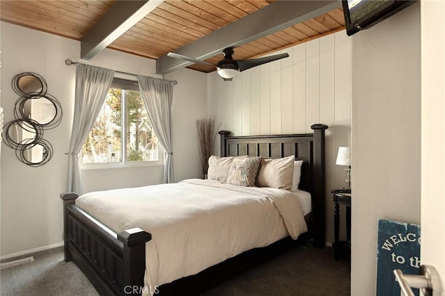 27482 Matterhorn Dr, Lake Arrowhead, CA 92352 - bedroom with a wooden ceiling with exposed beams, dark carpet, and ceiling fan