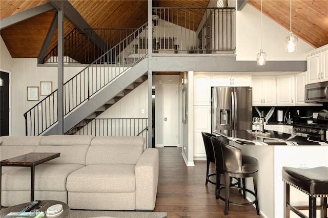 27482 Matterhorn Dr, Lake Arrowhead, CA 92352 - living room with dark wood-style flooring, a wood ceiling with exposed beams, high vaulted ceiling, and stairs