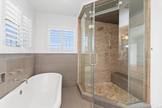 1045 Tarento Dr, San Diego, CA 92107 - bathroom featuring a freestanding bath, a shower stall, tile patterned floors, and tile walls