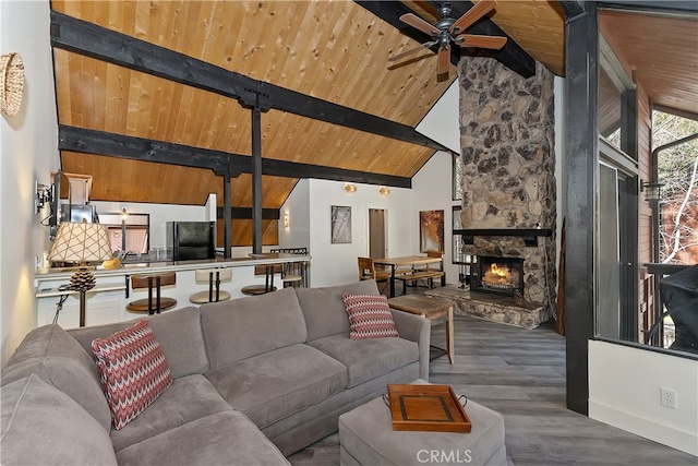 41935 Switzerland Dr Unit 100, Big Bear Lake, CA 92315 - living room featuring ceiling fan, a stone fireplace, wood ceiling, wood finished floors, and beam ceiling