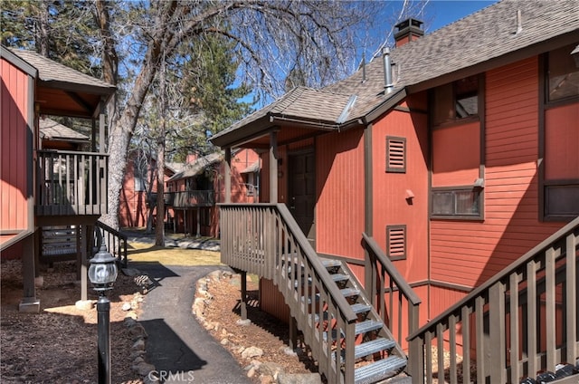 41935 Switzerland Dr Unit 100, Big Bear Lake, CA 92315 - view of home's exterior featuring roof with shingles and a chimney