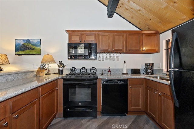 41935 Switzerland Dr Unit 100, Big Bear Lake, CA 92315 - kitchen with brown cabinets, dark wood-style floors, vaulted ceiling, and black appliances