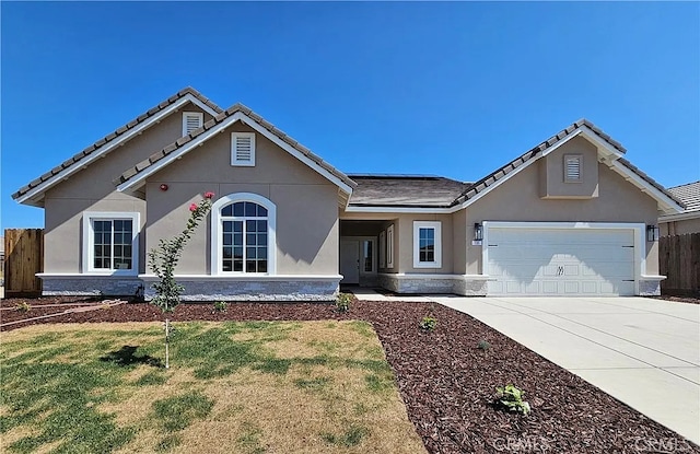 ranch-style house with a front yard, an attached garage, fence, stucco siding, and driveway