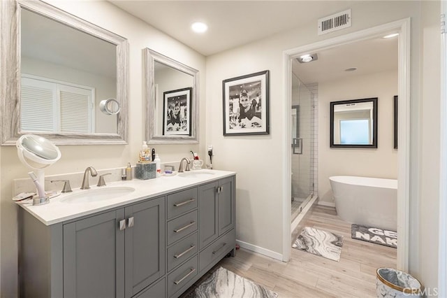 4054 Corte Cima, Thousand Oaks, CA 91360 - full bath with wood finished floors, a stall shower, double vanity, a freestanding bath, and baseboards