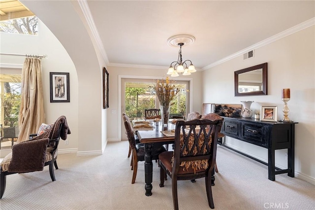4054 Corte Cima, Thousand Oaks, CA 91360 - dining area featuring ornamental molding, light carpet, a chandelier, baseboards, and arched walkways