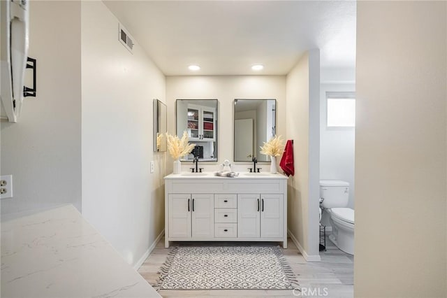 4054 Corte Cima, Thousand Oaks, CA 91360 - full bathroom featuring wood finished floors, double vanity, toilet, baseboards, and recessed lighting
