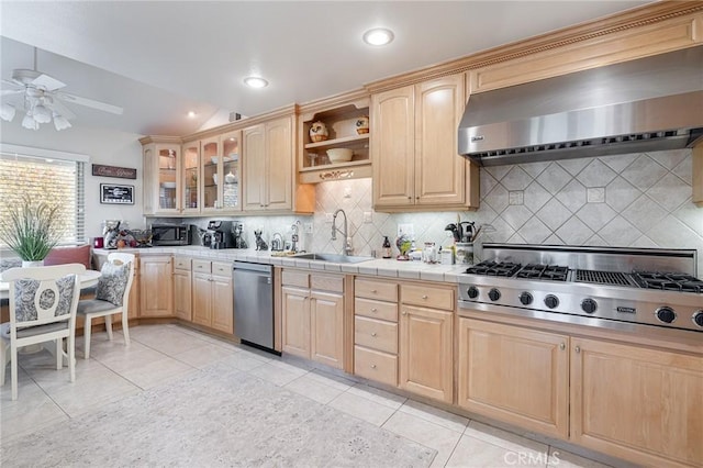4054 Corte Cima, Thousand Oaks, CA 91360 - kitchen featuring appliances with stainless steel finishes, light brown cabinetry, wall chimney exhaust hood, a sink, and light tile patterned flooring