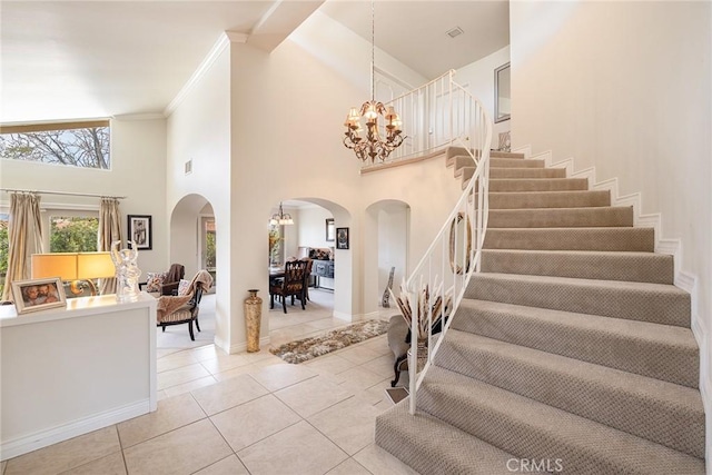 4054 Corte Cima, Thousand Oaks, CA 91360 - foyer entrance with arched walkways, a chandelier, stairway, a high ceiling, and light tile patterned flooring