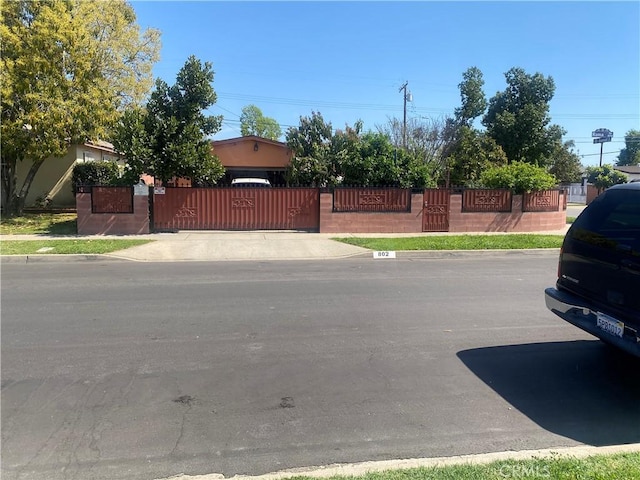 exterior space with a gate and curbs
