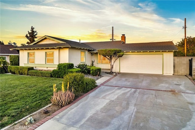 single story home with roof with shingles, an attached garage, a front lawn, a chimney, and driveway