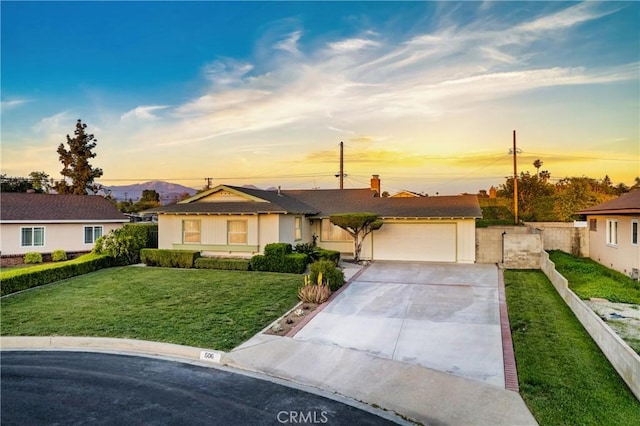 ranch-style home with driveway, a chimney, a front yard, a garage, and fence
