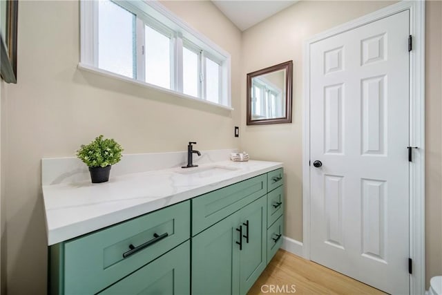 bathroom with vanity and wood finished floors