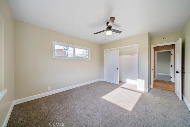 unfurnished bedroom featuring a closet, carpet, ceiling fan, and baseboards