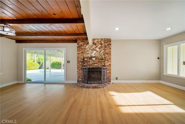 unfurnished living room featuring baseboards, a fireplace, and wood finished floors