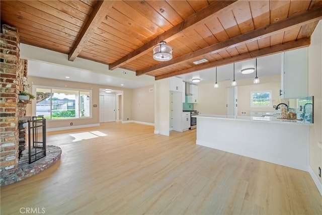 unfurnished living room with a brick fireplace, baseboards, wooden ceiling, and light wood finished floors
