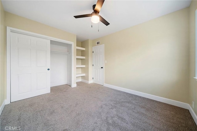 unfurnished bedroom with visible vents, carpet flooring, and baseboards