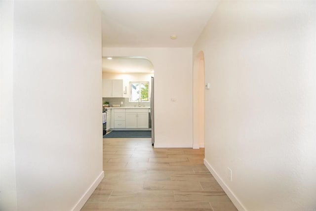 2821 Macdonald St, Oceanside, CA 92054 - hall with arched walkways and light wood finished floors
