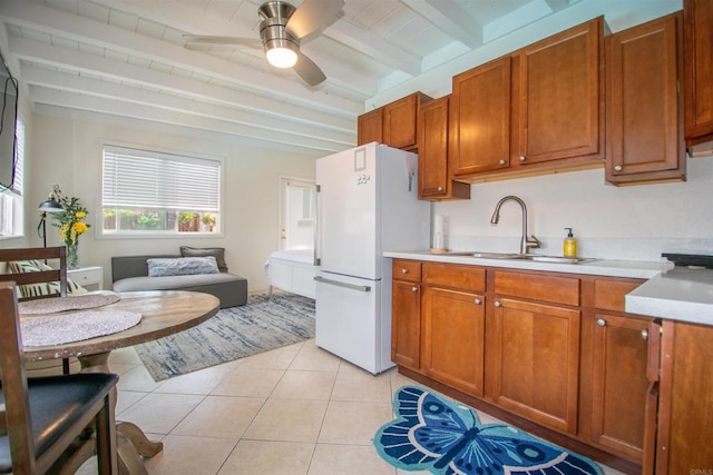 2821 Macdonald St, Oceanside, CA 92054 - kitchen featuring freestanding refrigerator, beamed ceiling, light countertops, a ceiling fan, and brown cabinets