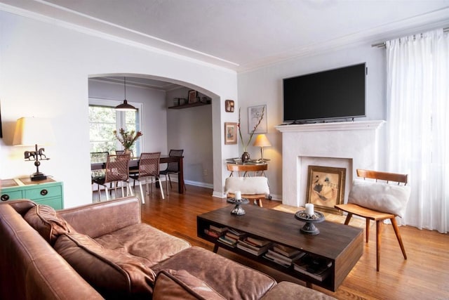 4640 Max Dr, San Diego, CA 92115 - living room featuring arched walkways, wood finished floors, crown molding, and a fireplace with flush hearth