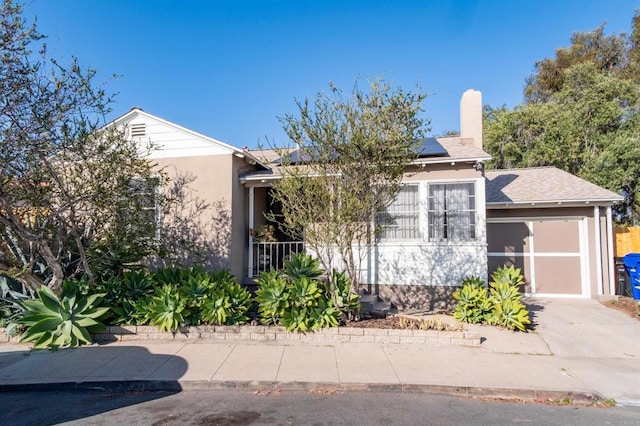 4640 Max Dr, San Diego, CA 92115 - view of property hidden behind natural elements with solar panels, driveway, a chimney, and stucco siding