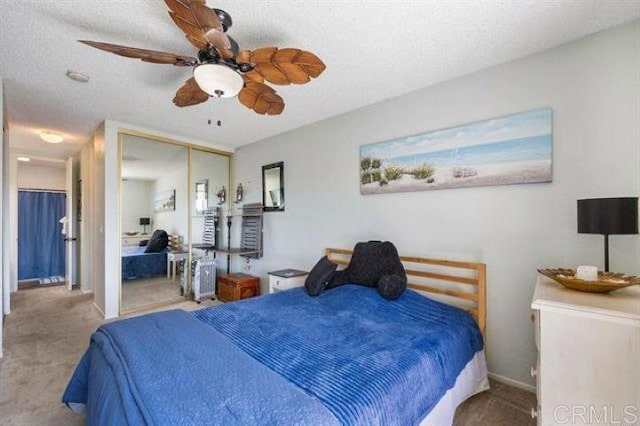 999 N Pacific St Unit G326, Oceanside, CA 92054 - bedroom featuring carpet flooring, a closet, baseboards, a ceiling fan, and a textured ceiling