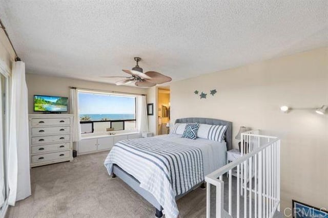 999 N Pacific St Unit G326, Oceanside, CA 92054 - bedroom with a textured ceiling, light carpet, and ceiling fan
