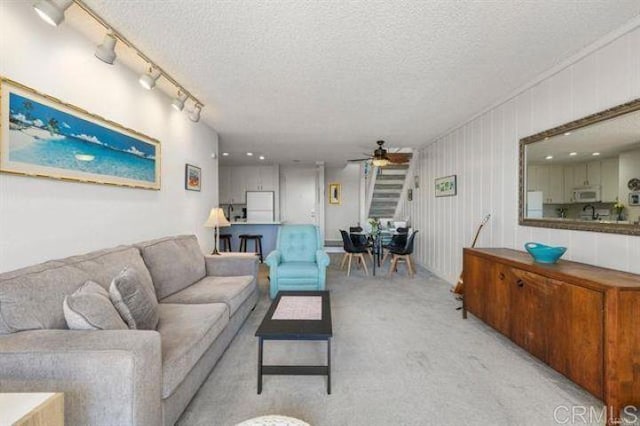 999 N Pacific St Unit G326, Oceanside, CA 92054 - living room with ceiling fan, a textured ceiling, and light colored carpet