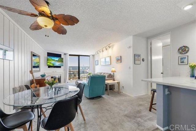 999 N Pacific St Unit G326, Oceanside, CA 92054 - dining space with a textured ceiling, light colored carpet, and ceiling fan
