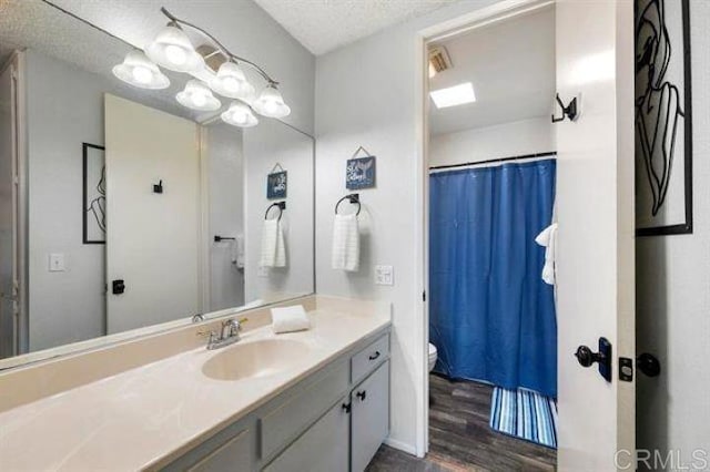 999 N Pacific St Unit G326, Oceanside, CA 92054 - full bathroom with toilet, vanity, wood finished floors, and a shower with curtain