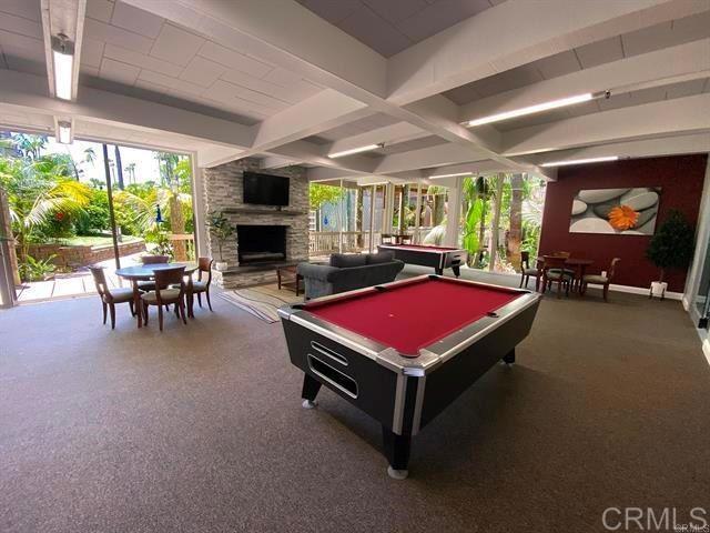 999 N Pacific St Unit G326, Oceanside, CA 92054 - playroom with billiards, beam ceiling, carpet, and a stone fireplace