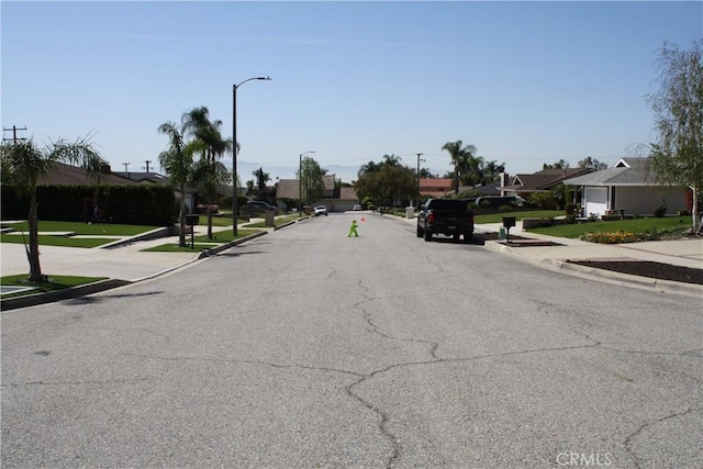 6320 Amberwood Dr, Rancho Cucamonga, CA 91701 - view of road featuring curbs, a residential view, street lights, and sidewalks