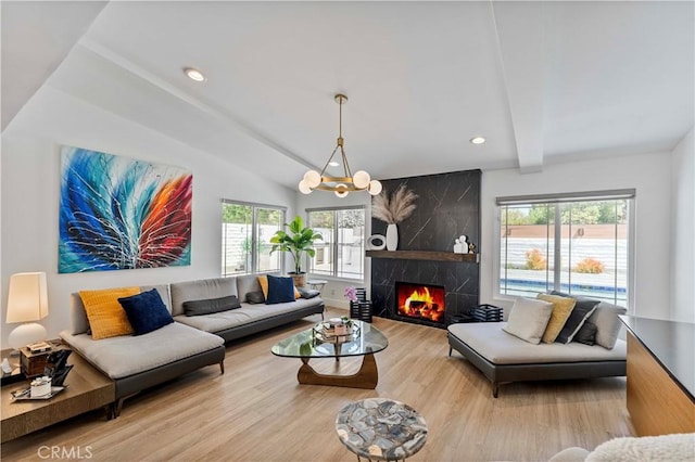 living room featuring plenty of natural light, a notable chandelier, vaulted ceiling with beams, and wood finished floors