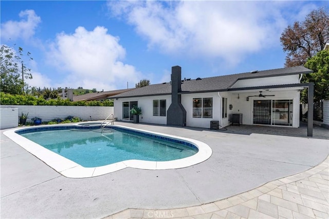 view of pool featuring a jacuzzi, a patio, a fenced backyard, and a fenced in pool